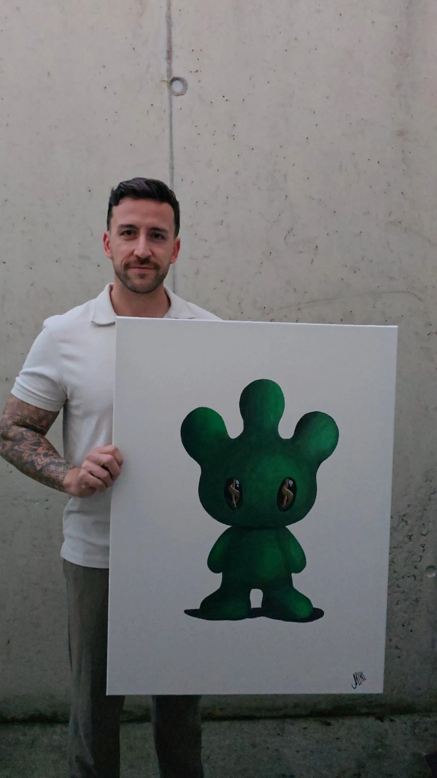 Sven Micklitz holding the original green MIKKI painting